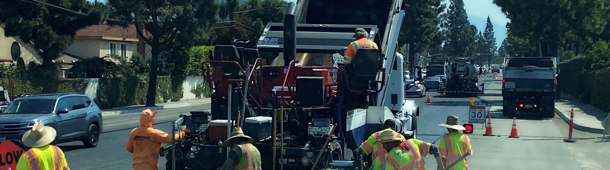 A B&D Transportation truck feeding a paving crew on a street rehabilitation job