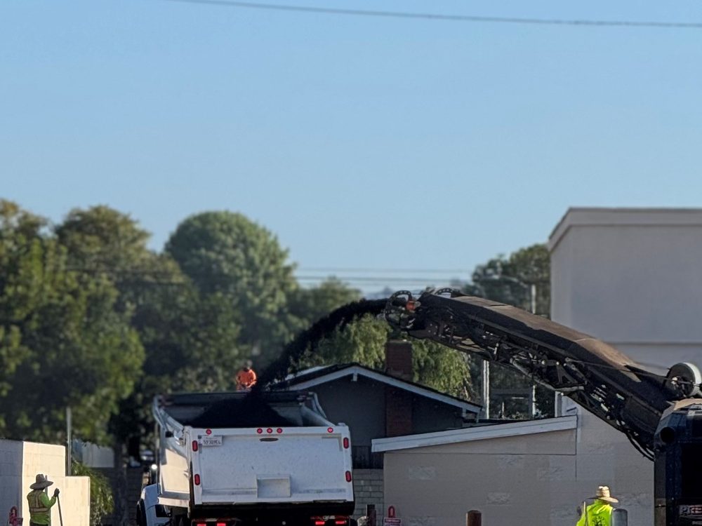 Pavement grinder loading recycled asphalt into a B&D Transportation truck